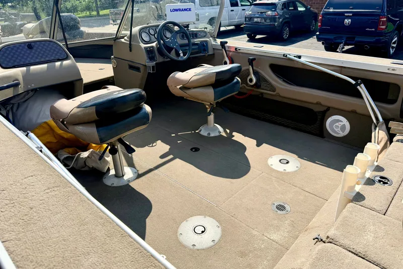 Slide: The Image of 2008 G3 Angler V185 FS boat interior with seating, steering wheel, and fishing rod holders. - 11