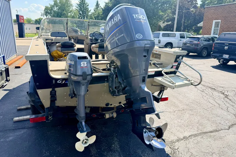 Slide: The Image of 2008 G3 Angler V185 FS boat with Yamaha outboard motors in a parking lot. - 10