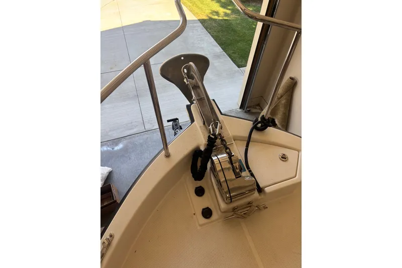 Slide: The Image of 2015 Ranger Tugs R-25 SC boat anchor and deck detail in a garage setting. - 14
