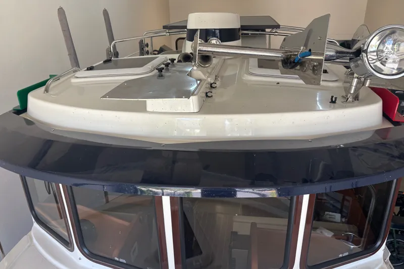 Slide: The Image of 2015 Ranger Tugs R-25 SC boat cabin with navigation equipment and spotlight. - 21