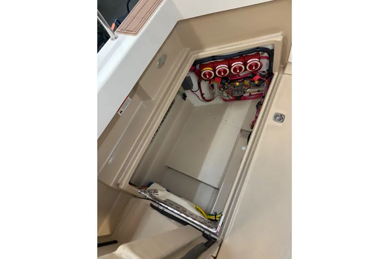Slide: The Image of 2015 Ranger Tugs R-25 SC engine compartment with visible wiring and components. - 18