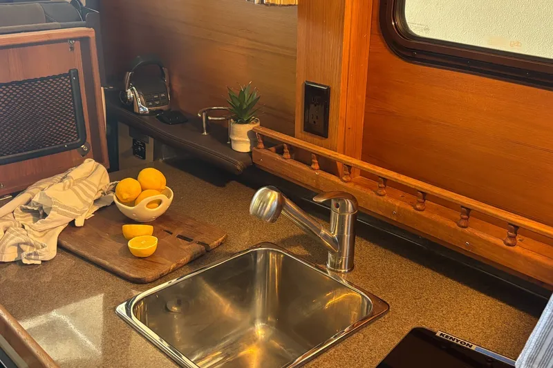 Slide: The Image of 2015 Ranger Tugs R-25 SC kitchen with lemons, sink, and wooden accents. - 29