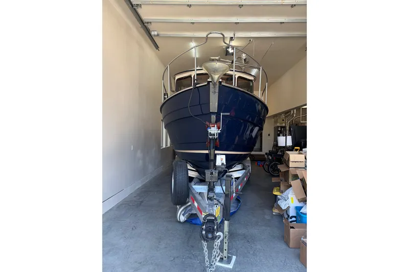 Slide: The Image of 2015 Ranger Tugs R-25 SC boat in garage, front view, on trailer. - 37