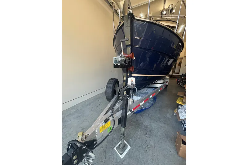 Slide: The Image of 2015 Ranger Tugs R-25 SC boat on trailer in garage setting. - 38
