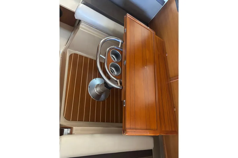 Slide: The Image of 2015 Ranger Tugs R-25 SC interior with wooden table and cup holders. - 33