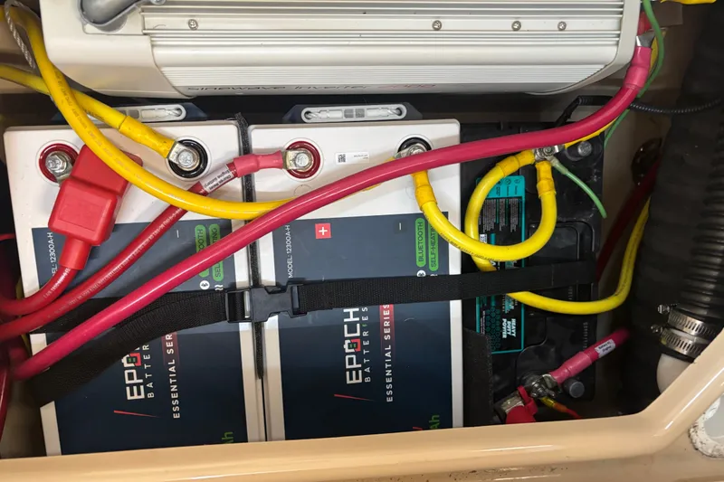 Slide: The Image of Battery compartment of 2015 Ranger Tugs R-25 SC with connected cables and components. - 26
