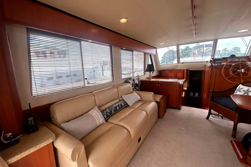 Slide: The Image of Interior of 2008 Mainship 34 Trawler with beige sofa and wooden accents. - 6