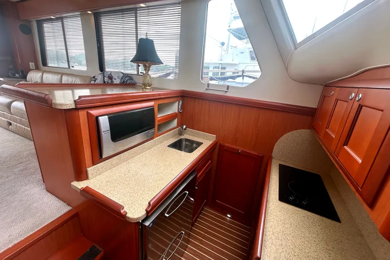Slide: The Image of Luxurious interior of 2008 Mainship 34 Trawler with modern kitchen amenities. - 14