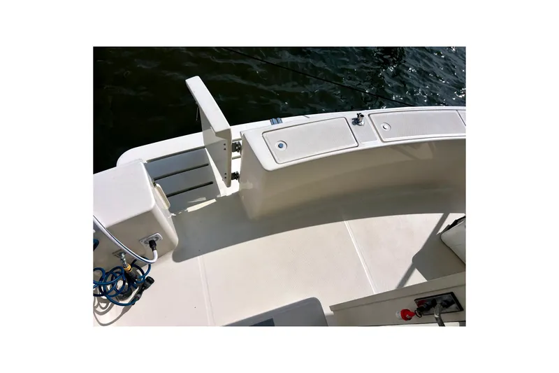 Slide: The Image of 2008 Mainship 34 Trawler deck with storage compartments and water hose. - 42