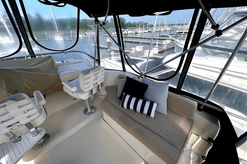 Slide: The Image of Interior of 2008 Mainship 34 Trawler with seating and marina view. - 25