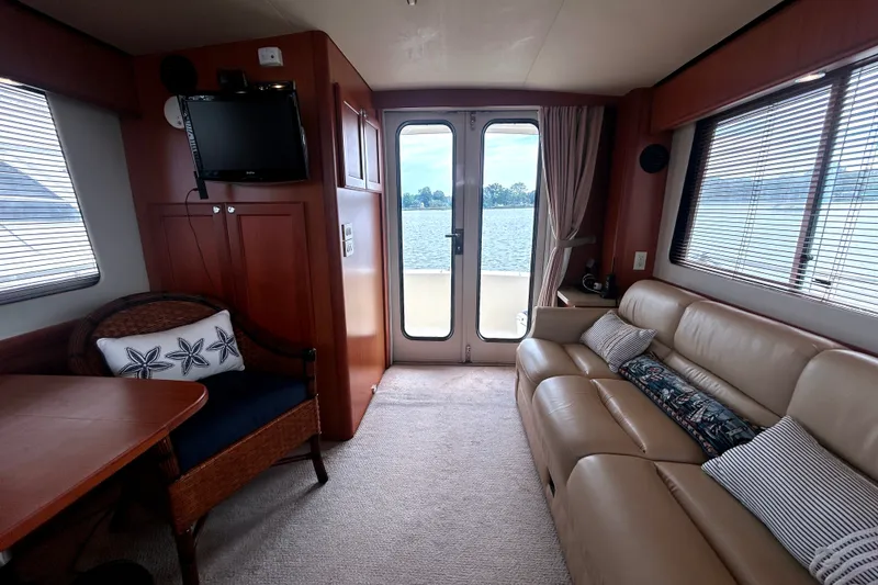 Slide: The Image of Interior of 2008 Mainship 34 Trawler with leather seating and lake view. - 11