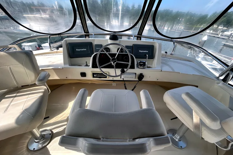 Slide: The Image of Helm of 2008 Mainship 34 Trawler with Raymarine electronics, featuring three comfortable seats. - 29