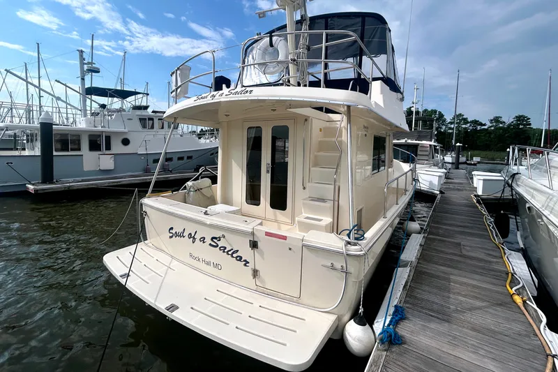 Slide: The Image of 2008 Mainship 34 Trawler docked at marina, featuring "Soul of a Sailor" name. - 2