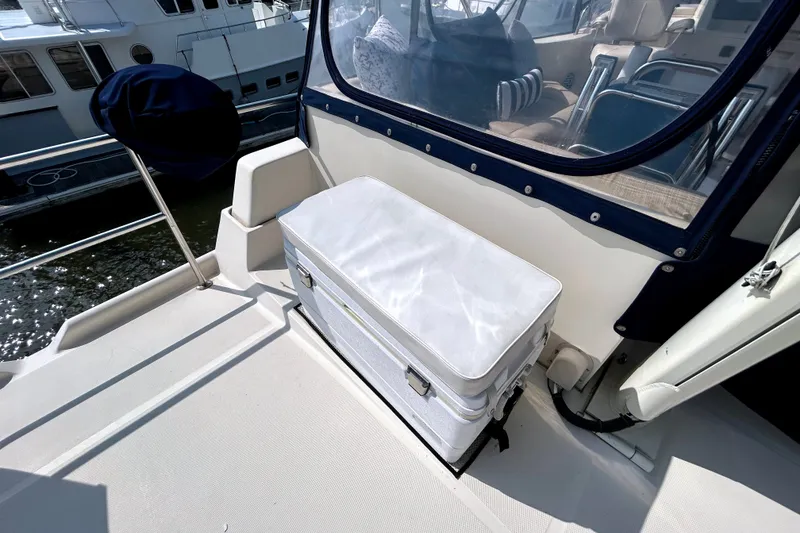 Slide: The Image of 2008 Mainship 34 Trawler deck with seating and storage, docked at marina. - 38