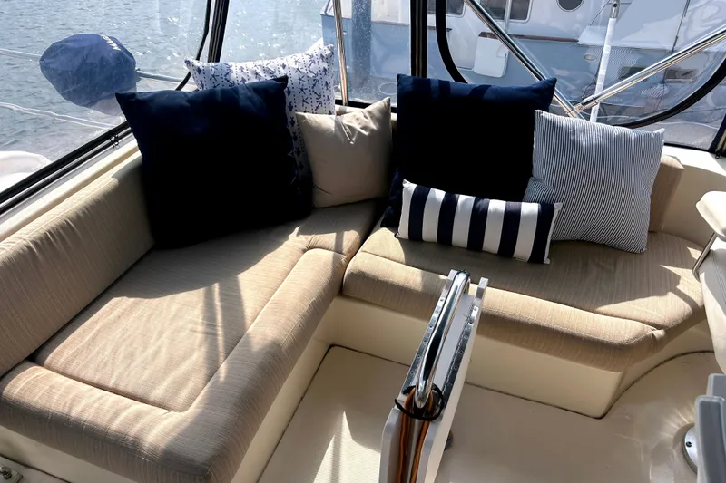 Slide: The Image of Cozy seating area on 2008 Mainship 34 Trawler with nautical-themed cushions. - 26