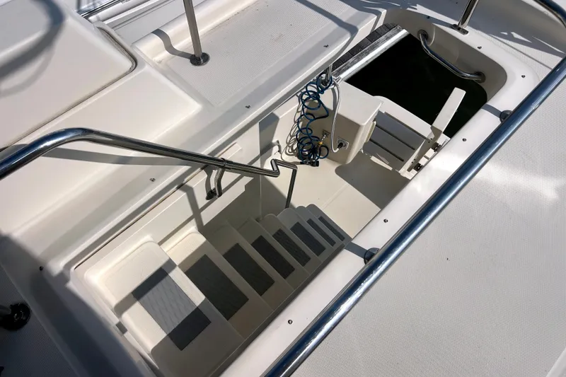Slide: The Image of Staircase on 2008 Mainship 34 Trawler, featuring stainless steel railings and non-slip steps. - 40