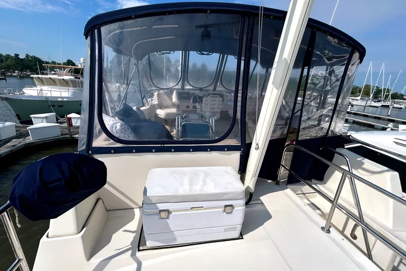 Slide: The Image of 2008 Mainship 34 Trawler with enclosed helm, docked at marina under clear skies. - 36