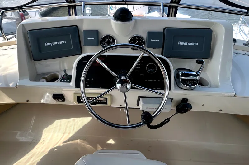 Slide: The Image of 2008 Mainship 34 Trawler helm with Raymarine electronics and steering wheel. - 30