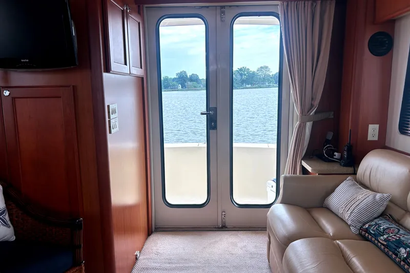 Slide: The Image of Interior of 2008 Mainship 34 Trawler with lake view through glass doors. - 10