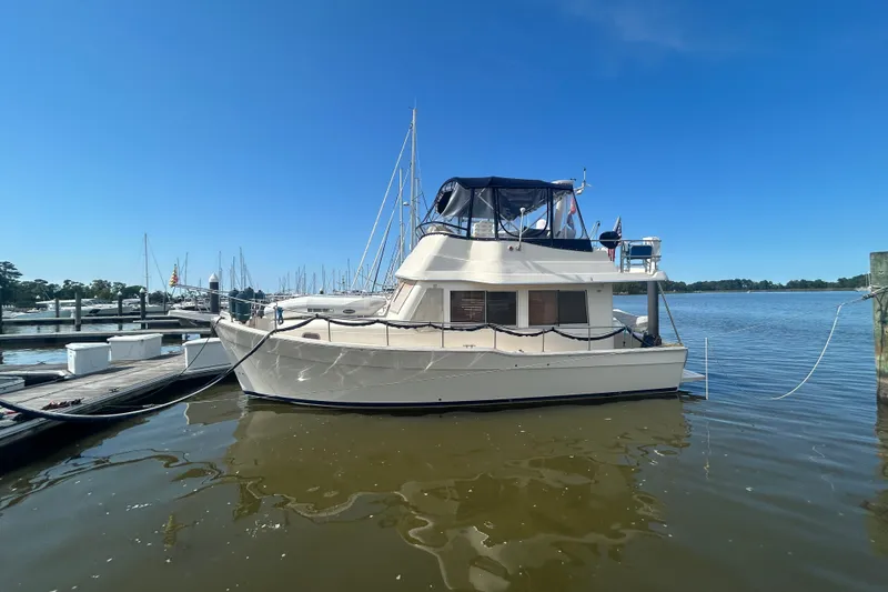 Slide: The Image of 2008 Mainship 34 Trawler docked at marina under clear blue sky. - 3