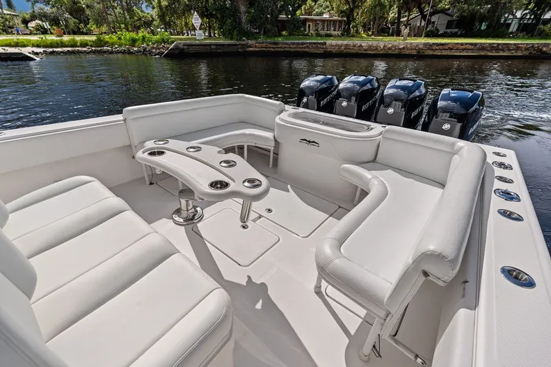 Slide: The Image of 2018 Invincible 42 Center Cabin boat with spacious seating and multiple outboard engines. - 14