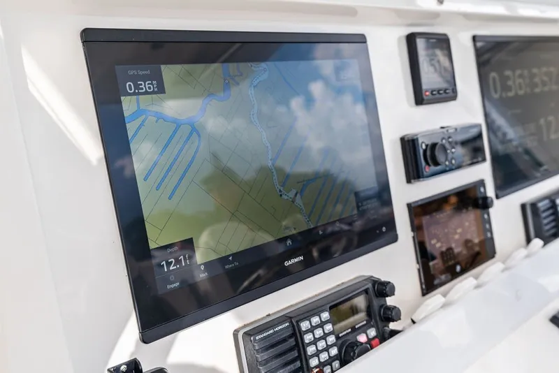 Slide: The Image of Dashboard of 2018 Invincible 42 Center Cabin with navigation and communication equipment. - 26