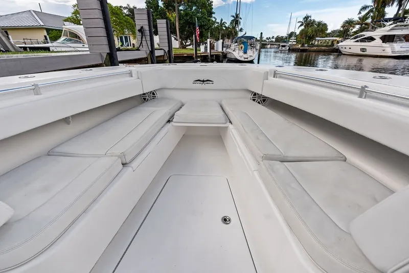 Slide: The Image of 2018 Invincible 42 Center Cabin boat interior with cushioned seating and sleek design. - 34