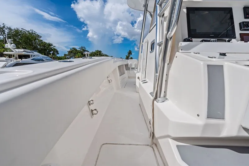 Slide: The Image of 2018 Invincible 42 Center Cabin boat deck with clear blue sky background. - 28