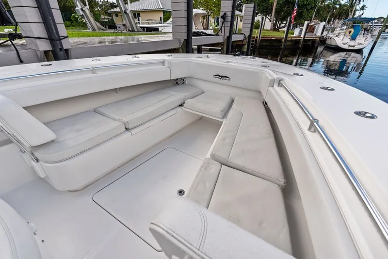 Slide: The Image of 2018 Invincible 42 Center Cabin boat with spacious seating area at dock. - 33