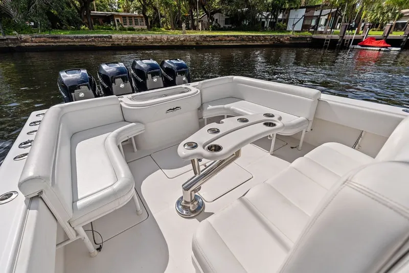 Slide: The Image of 2018 Invincible 42 Center Cabin boat with spacious seating and multiple outboard engines. - 13