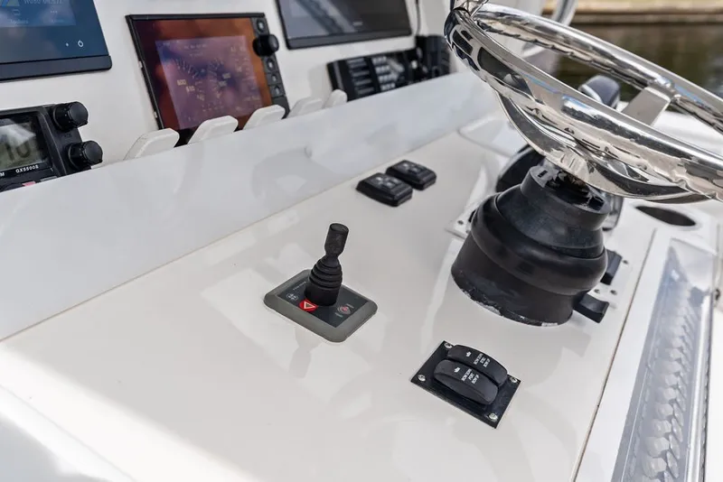 Slide: The Image of Control panel of 2018 Invincible 42 Center Cabin boat with steering wheel and navigation instruments. - 25