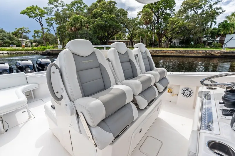 Slide: The Image of 2018 Invincible 42 Center Cabin boat interior with luxurious seating and scenic waterway view. - 20