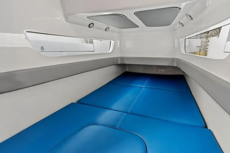 Slide: The Image of Interior cabin of 2018 Invincible 42 Center Cabin boat with blue cushions. - 40