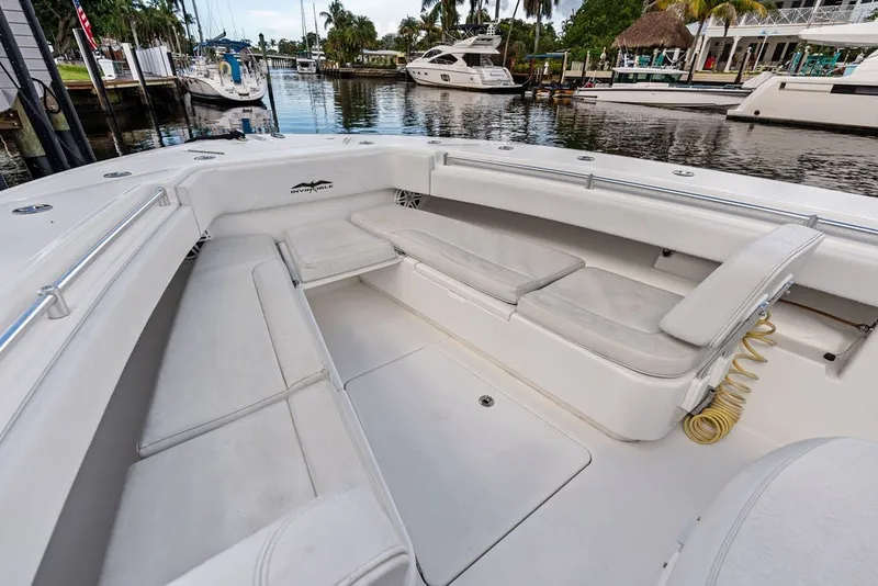 Slide: The Image of Spacious seating area on 2018 Invincible 42 Center Cabin boat docked by waterfront. - 32