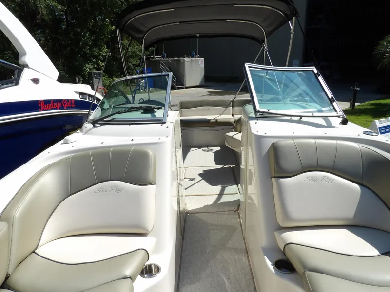 Slide: The Image of 2005 Sea Ray 240 Sundeck interior with seating and open deck view. - 19