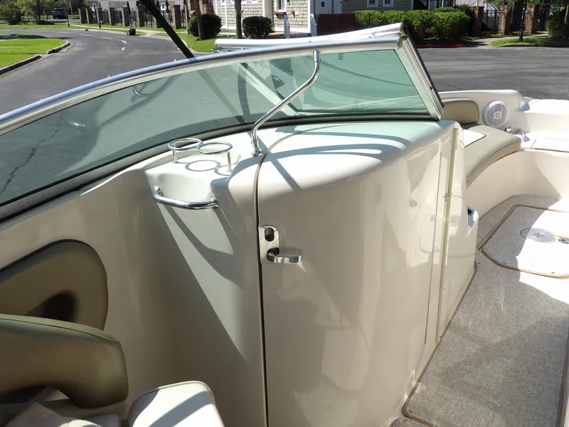 Slide: The Image of 2005 Sea Ray 240 Sundeck interior with seating and windshield, showcasing elegant design. - 28