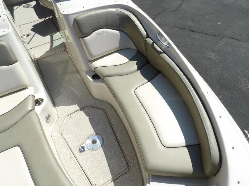 Slide: The Image of 2005 Sea Ray 240 Sundeck interior seating with beige upholstery. - 21