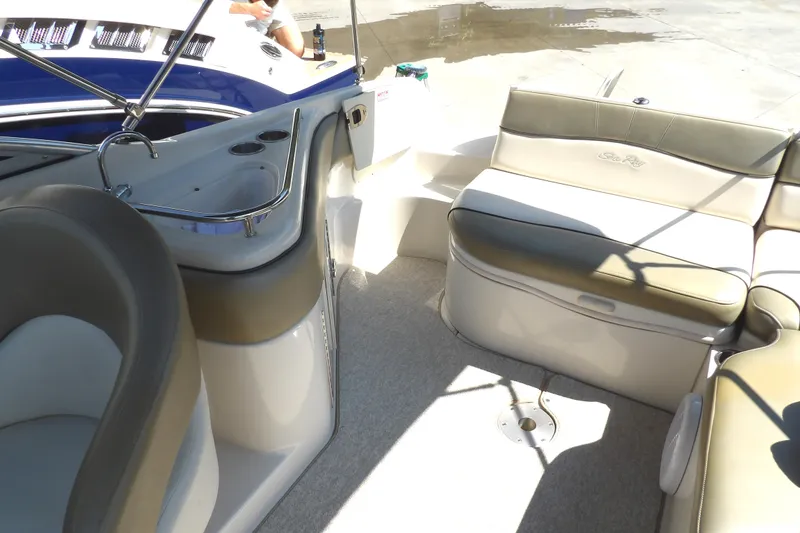 Slide: The Image of 2005 Sea Ray 240 Sundeck interior with seating and helm, showcasing luxury boat design. - 25