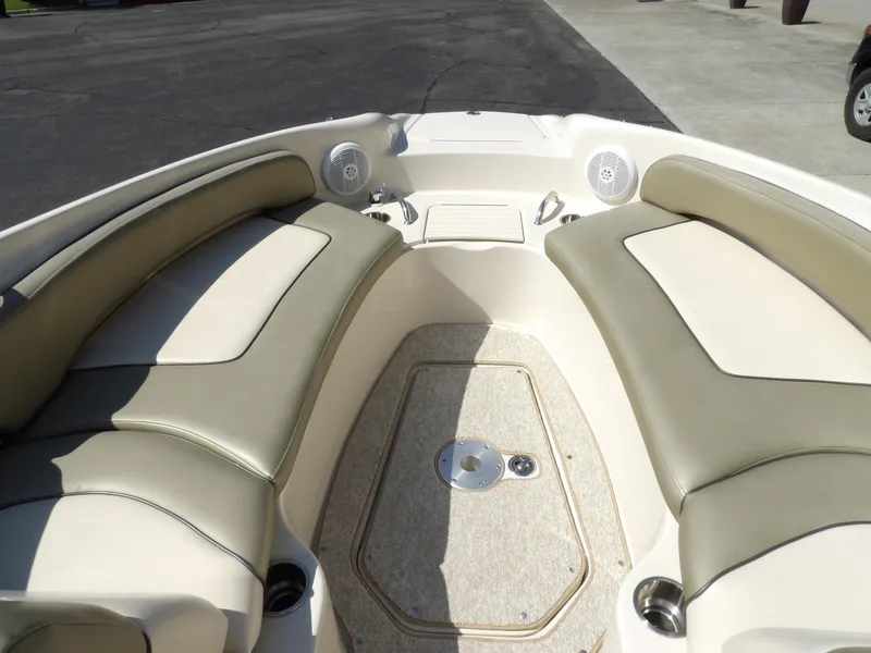 Slide: The Image of 2005 Sea Ray 240 Sundeck boat interior with beige seating and speakers. - 18