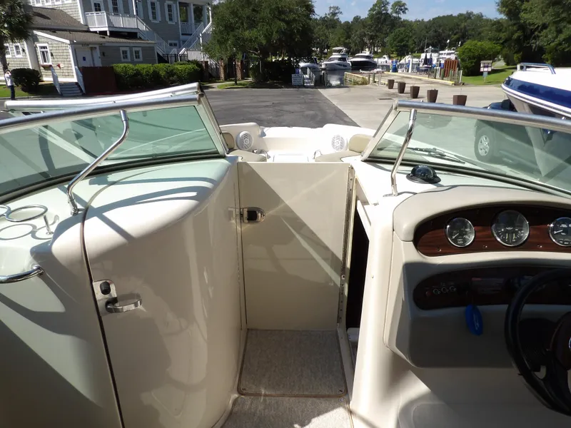 Slide: The Image of 2005 Sea Ray 240 Sundeck interior with dashboard and open walkway. - 23