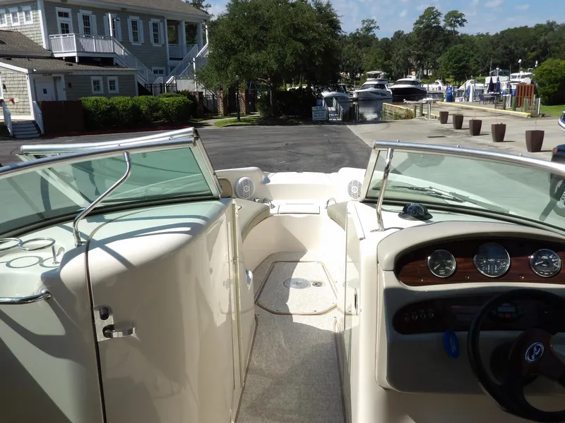 Slide: The Image of 2005 Sea Ray 240 Sundeck boat interior with dashboard and seating area. - 16
