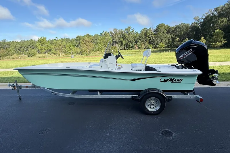 The Image of 2027 Mako Pro Skiff 17 CC boat on trailer, parked outdoors with scenic background. - 0