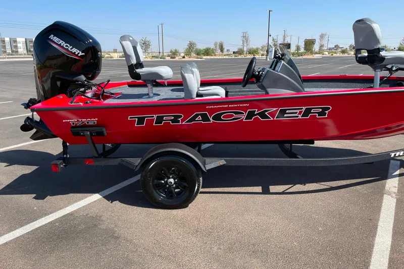 The Image of 2027 Tracker Pro Team 175 Crappie Edition boat in vibrant red, parked on a trailer. - 0