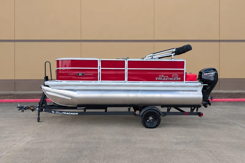 The Image of 2027 Sun Tracker Party Barge 16 DLX pontoon boat on trailer, side view. - 0
