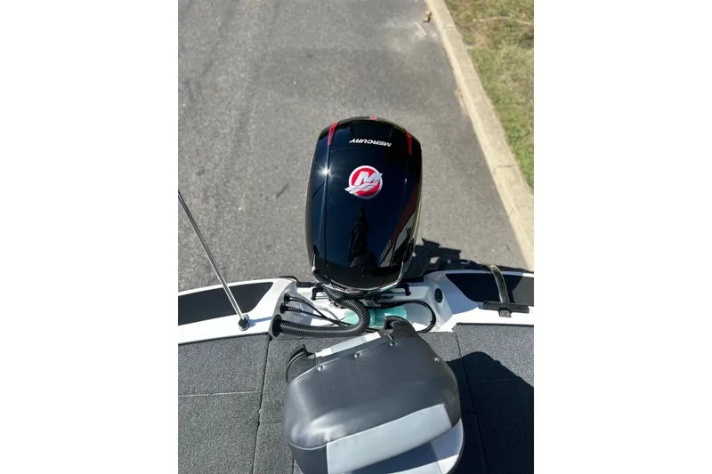 Slide: The Image of Top view of a 2027 Nitro Z18 XL Pro boat with Mercury engine on pavement. - 8