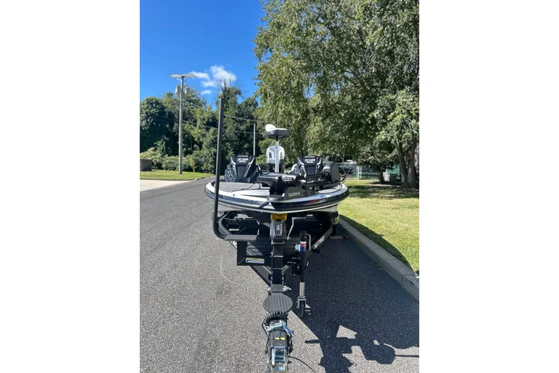 Slide: The Image of 2027 Nitro Z18 XL Pro boat on a sunny street, surrounded by trees. - 5