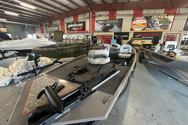 Slide: The Image of 2027 Tracker Bass Tracker Classic Limited boat in showroom with fishing gear. - 41