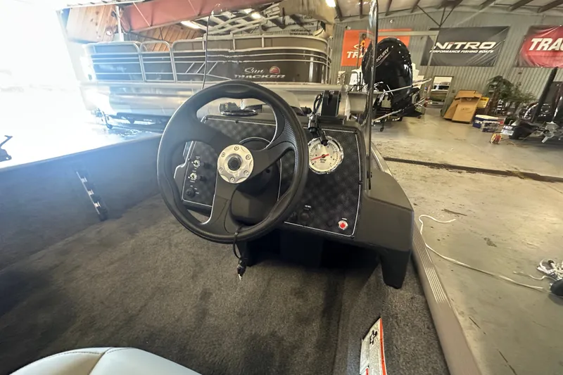 Slide: The Image of Interior view of 2027 Tracker Bass Tracker Classic Limited boat dashboard in a showroom. - 38
