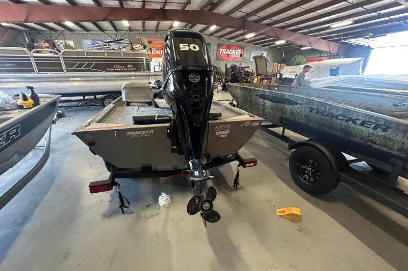 Slide: The Image of 2027 Tracker Bass Tracker Classic Limited boat in showroom, rear view with motor. - 39
