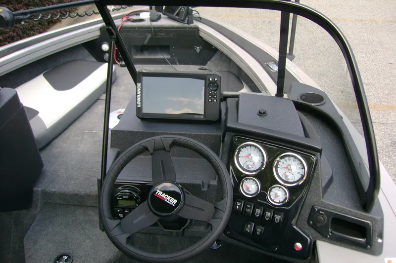 Slide: The Image of 2027 Tracker Targa V-18 Combo boat dashboard with steering wheel and gauges. - 13